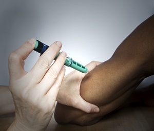 A person with diabetes being injected with insulin to regulate their blood sugar levels.